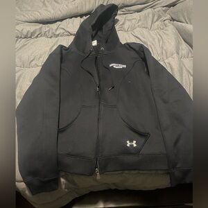 Hooded Under Armour zip up women’s jacket. Black with pockets in the front.